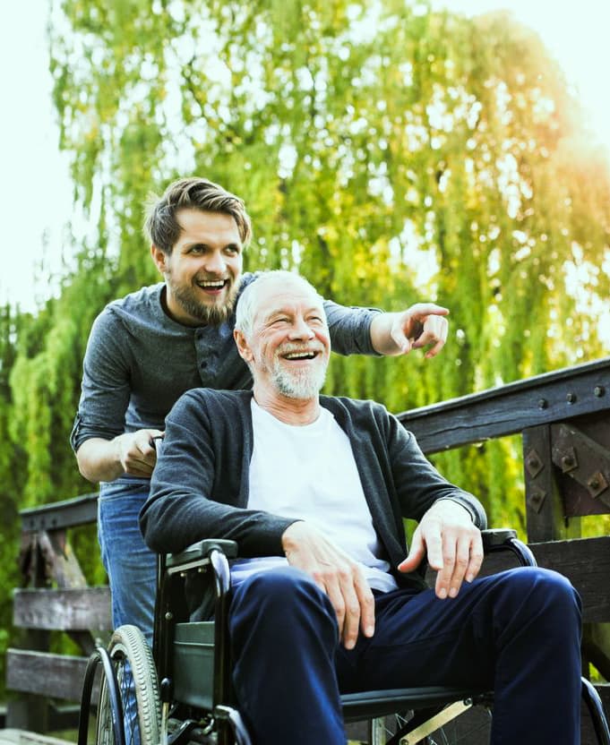 Caregiver supporting an elderly man